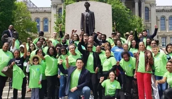 Group shot of Cannabis Equity Illinois Coalition members in front of statue